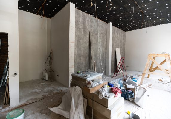 Workers are installing plasterboard for gypsum walls in apartment is under construction, remodeling, renovation, extension, restoration and reconstruction.
